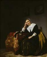 A Woman seated beside a Table