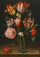 Still life of tulips, carnations, a rose and other flowers in a glass beaker  on a wooded ledge