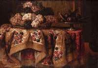 Grapes in a basket with sweetmeats on a salver on a draped table