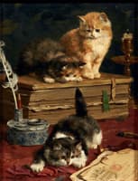 kittens playing by an inkwell