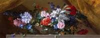 Flowers in a glass vase on a marble ledge