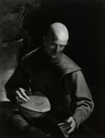 Old man tuning a lute