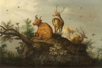 Deer and cattle on a hill in wooded landscape