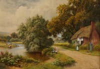 A thatched English cottage on a lake shore