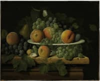 Peaches, grapes and a pear in a ceramic dish on a stone ledge with a pear, walnuts and butterflie