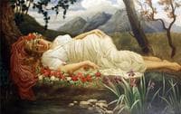 Portrait of a classical beauty on a bed of roses before a pond