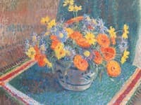 A still life of summer flowers in a pottery bowl on a table