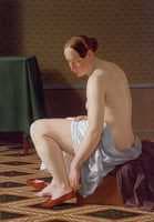 Naked woman putting on her shoes