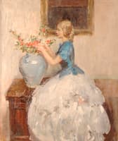 Woman tending to flowers in a vase