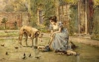 Young girl feeding the dogs